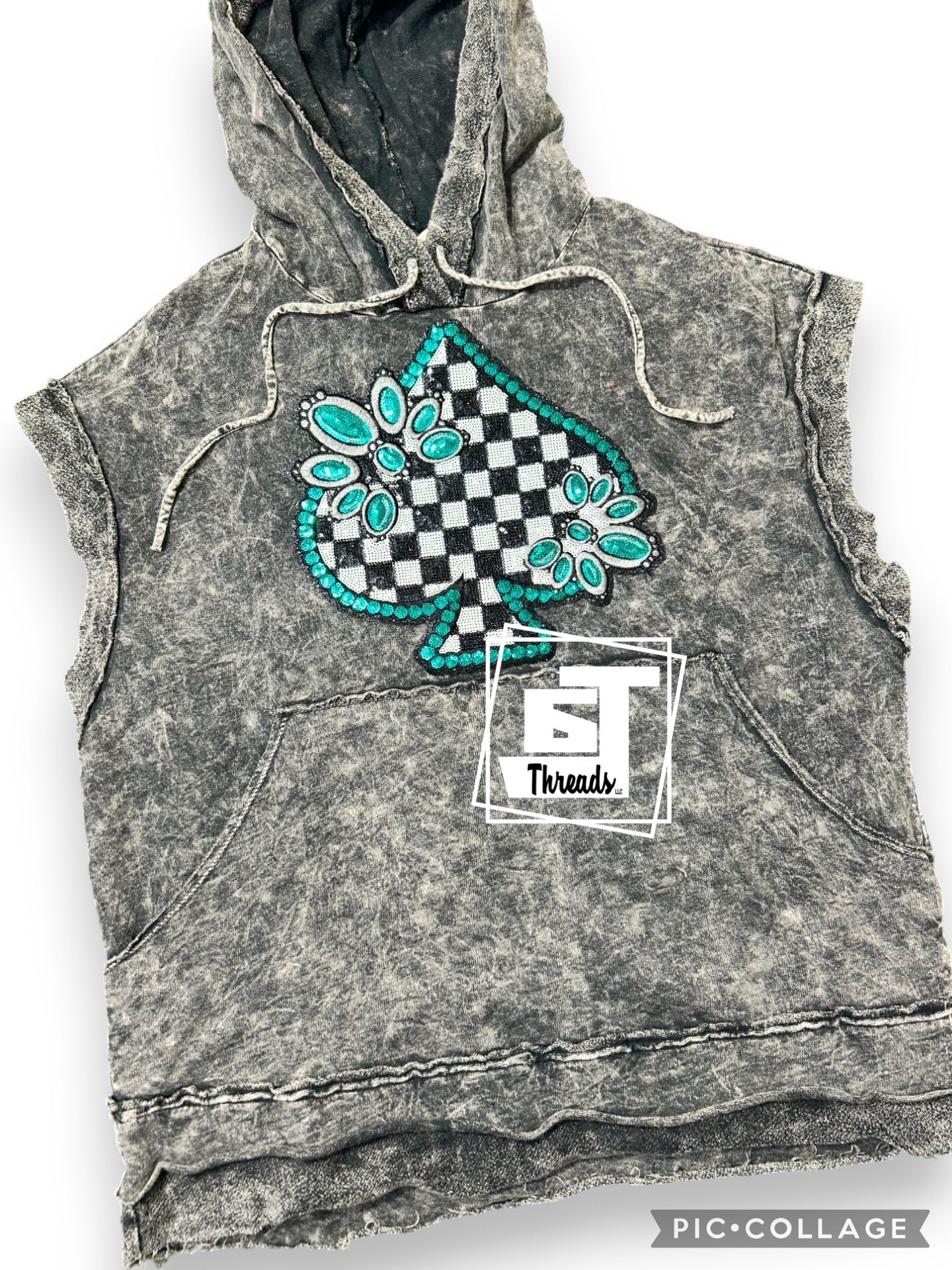 Turquoise spade sequence patch on a black acid wash T-shirt hoodie