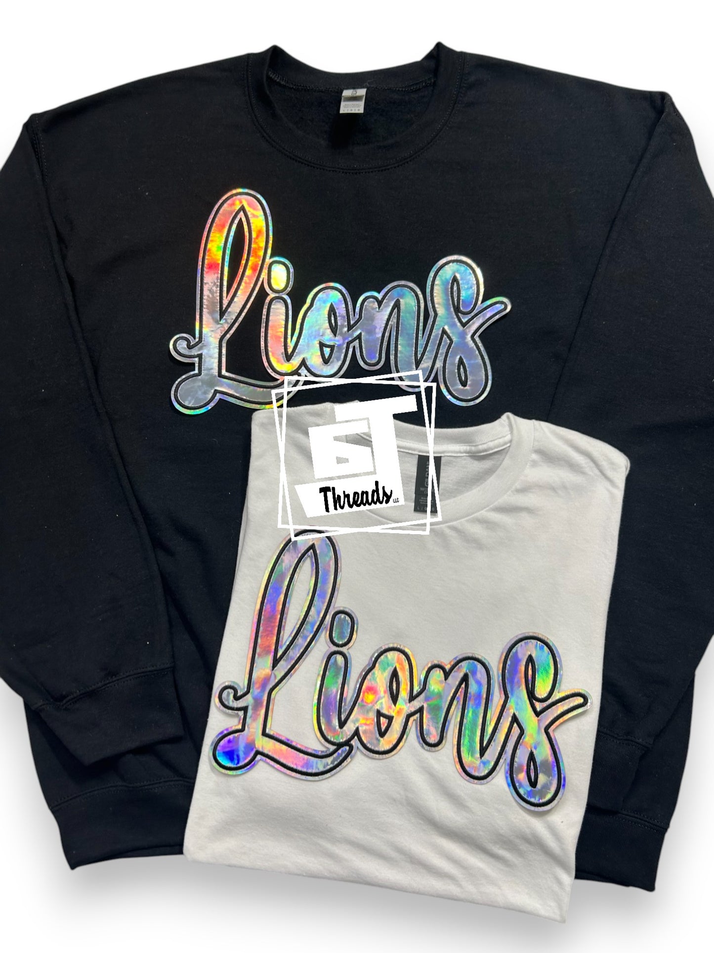 Silver Cursive Metallic Lions patch on black sweatshirt