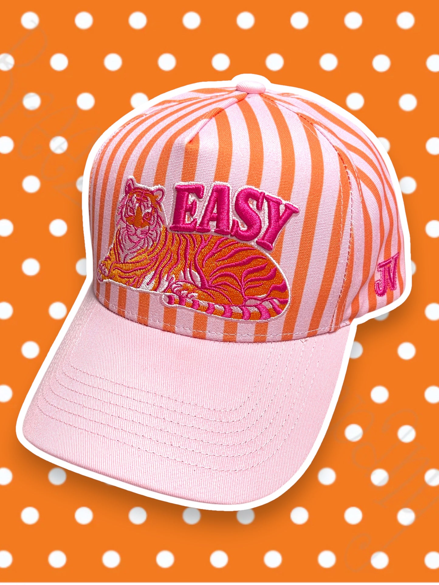 Pink and orange striped cap with tiger design and 'EASY' text on a polka dot background
