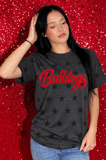 Person wearing a black t-shirt with 'Bulldogs' in red text against a red sequin background