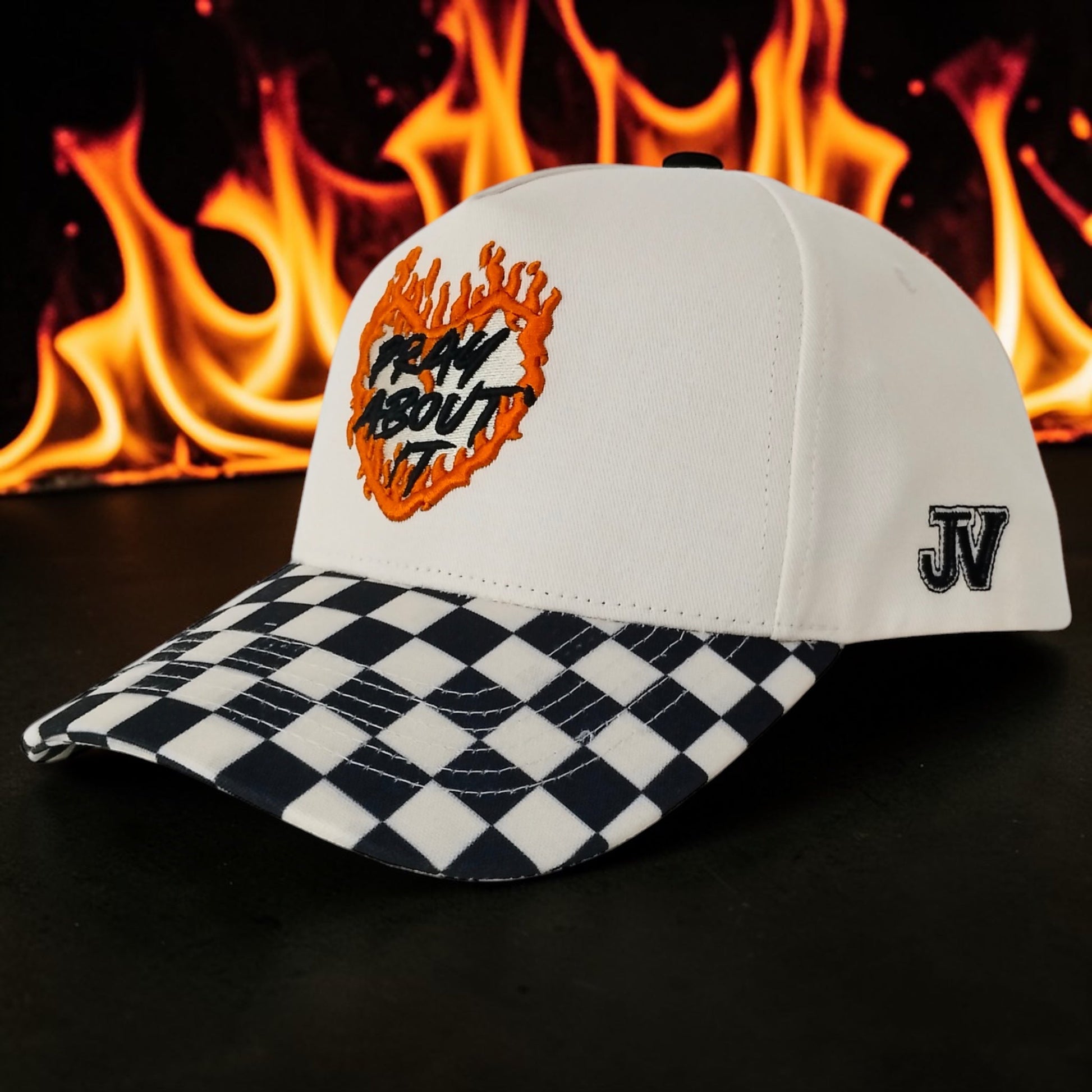 White cap with checkered brim and flame design against a fiery background