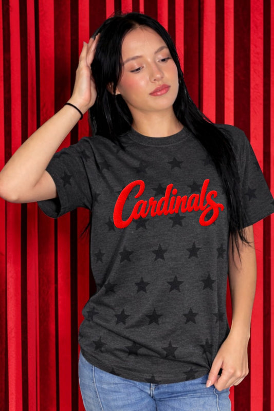 Woman wearing a black t-shirt with 'Cardinals' in red text against a red curtain background