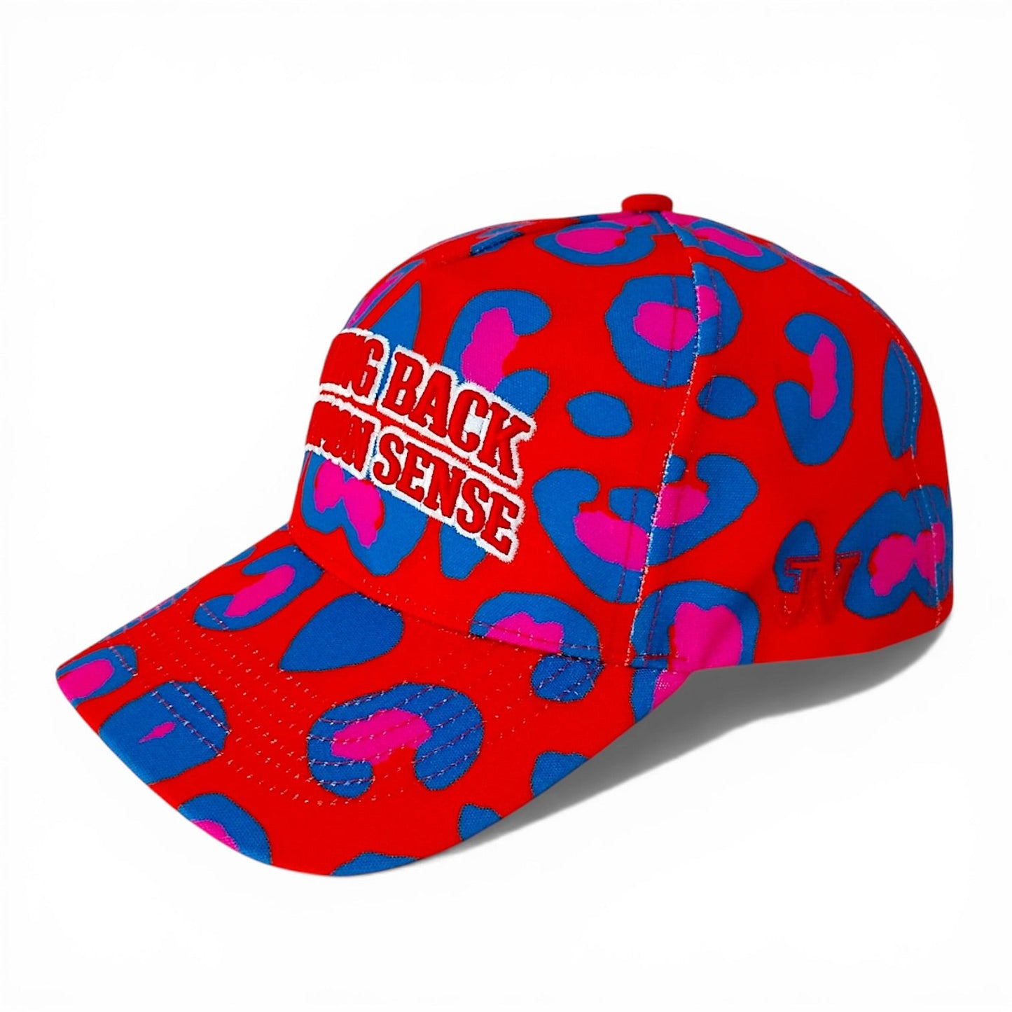 Red cap with blue and pink question mark pattern and text on a white background
