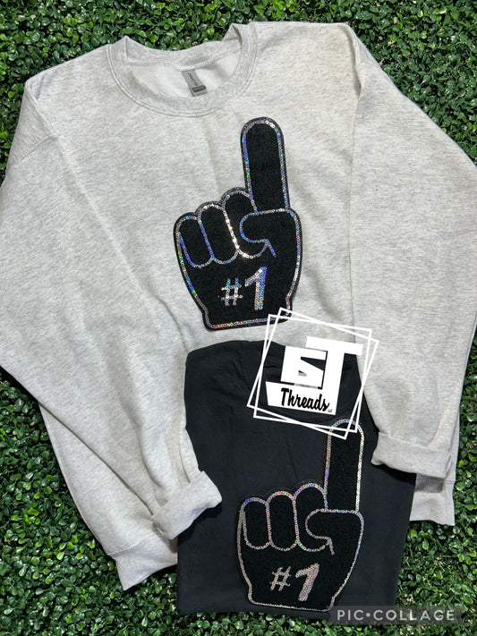foam finger patch on gray sweatshirt and black shirt