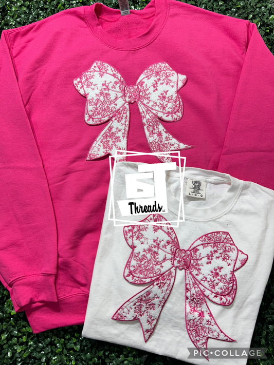 pink floral bow on pink sweatshirt and white shirt