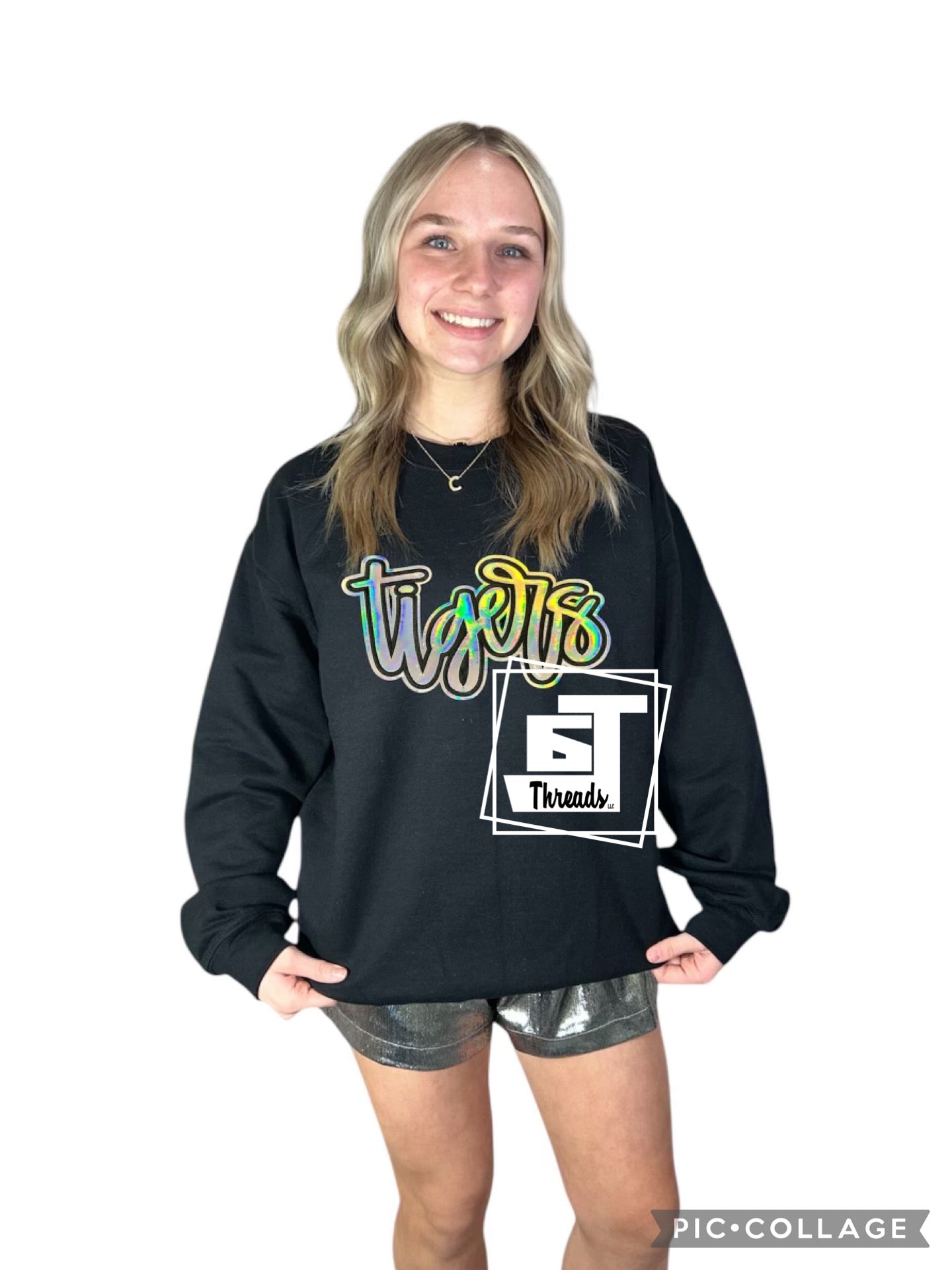 Metallic cursive, silver tigers on a black sweat sweatshirt
