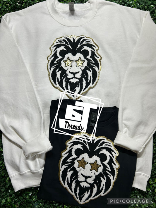 black and gold star eye lion patch on white sweatshirt and black shirt