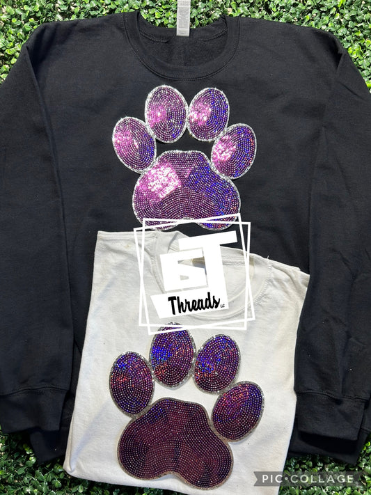 purple sequin paw print patch on black sweatshirt and white shirt
