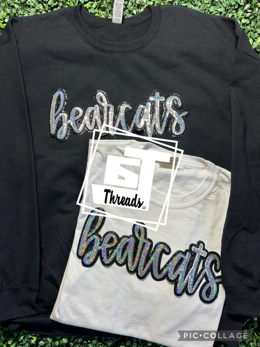cursive sequin bearcats patch on black sweatshirt and white shirt