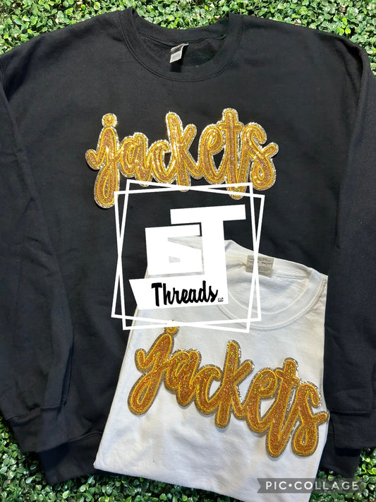 gold cursive sequin jackets patch on black sweatshirt and white shirt