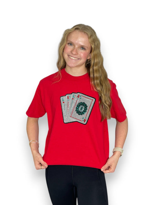 Person wearing a red t-shirt with a graphic design on a white background