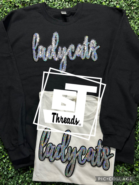cursive sequin lady cats patch on black sweatshirt and white shirt