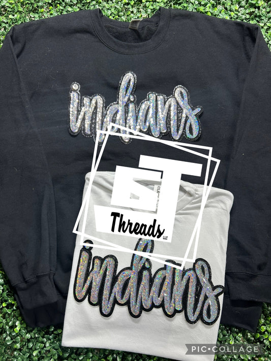 cursive sequin indians patch on black sweatshirt and white shirt