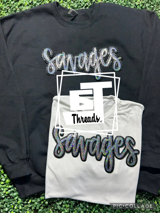 cursive sequin savages patch on black sweatshirt and white shirt