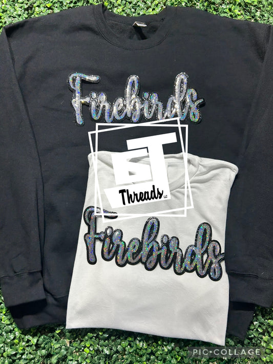 cursive sequin firebirds patch on black sweatshirt and white shirt