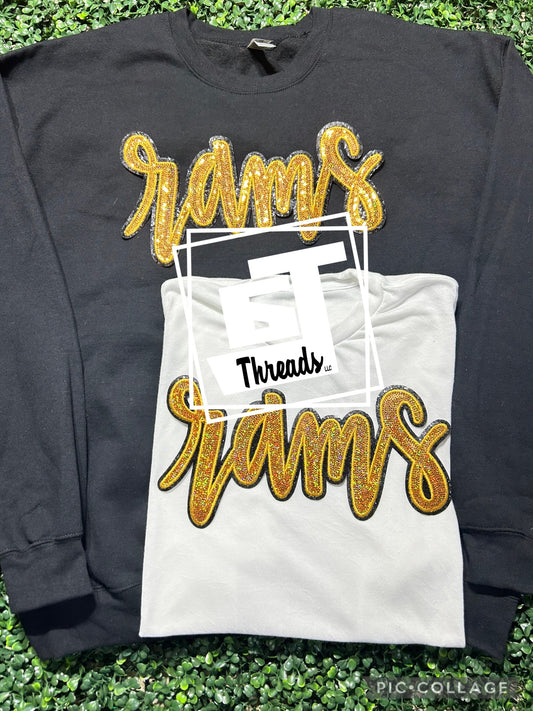 gold cursive sequin rams patch on black sweatshirt and white shirt