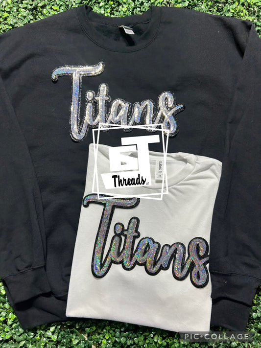 cursive sequin titans patch on black sweatshirt and white shirt