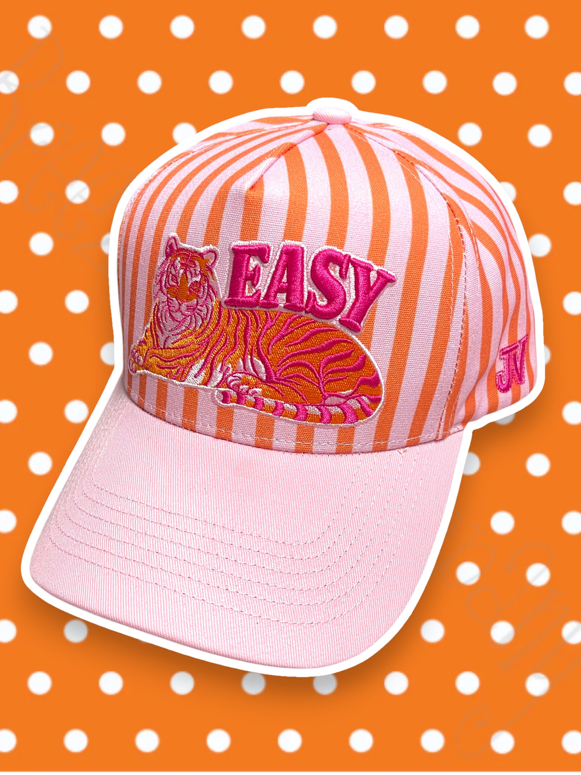 Pink and orange striped cap with tiger design and 'EASY' text on a polka dot background