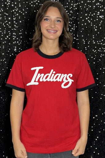 Person wearing a red 'Indians' t-shirt against a black background with white specks
